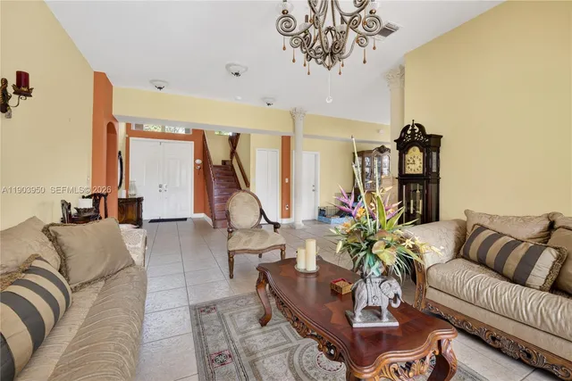 a living room with furniture or couch and a chandelier