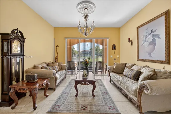 a living room with furniture and a chandelier