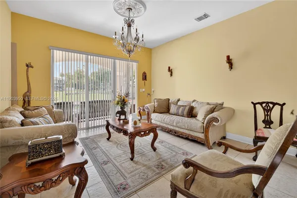a living room with furniture and a chandelier
