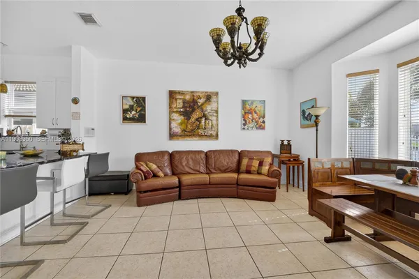 a living room with furniture a dining table and a window