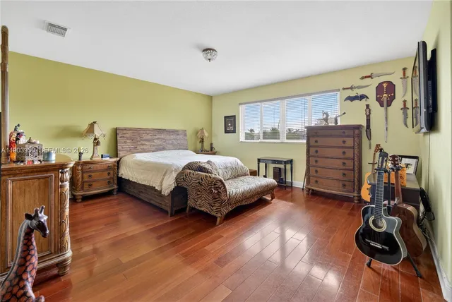 a bedroom with a bed and a dresser