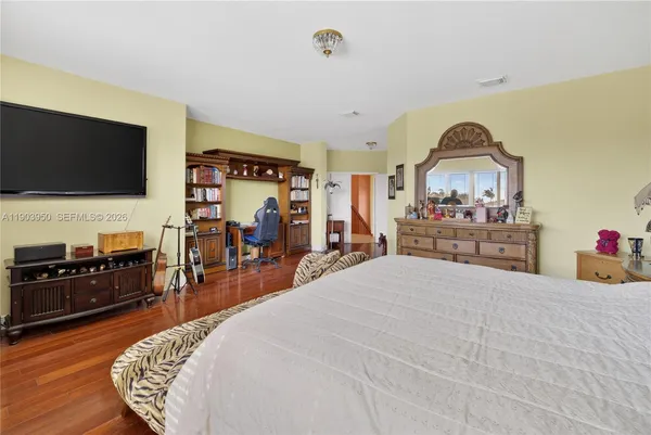 a bedroom with a bed and a flat screen tv
