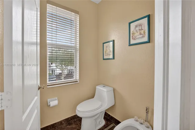 a white toilet sitting next to a bathroom sink