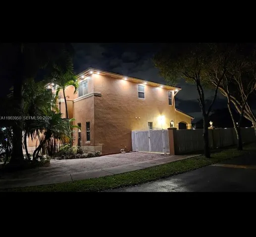 a view of a pathway of a house with a yard