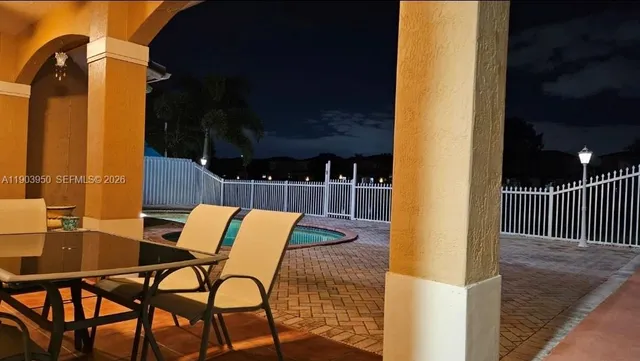 a view of patio with a table and chairs and wooden floor