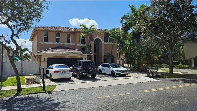 a view of a patio with couches a table and chairs and potted plants