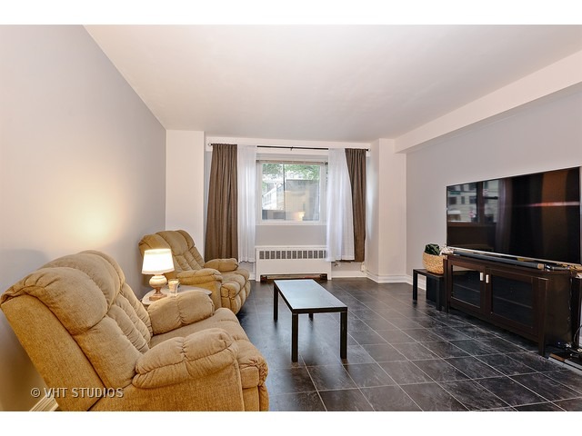 2909 North Sheridan Road, Unit 112 Chicago, IL 60657 - Photo 2 of 12 a living room with furniture and a flat screen tv