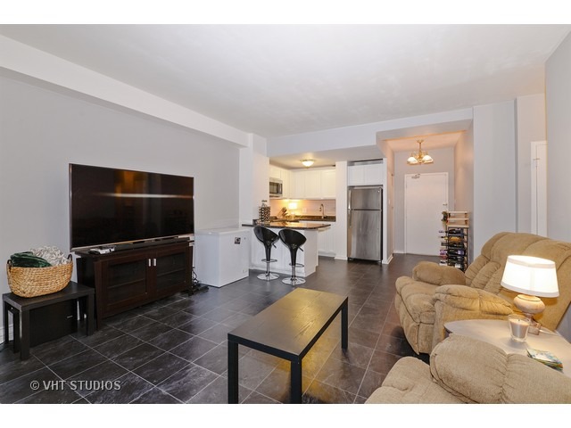 2909 North Sheridan Road, Unit 112 Chicago, IL 60657 - Photo 4 of 12 a living room with furniture and a flat screen tv
