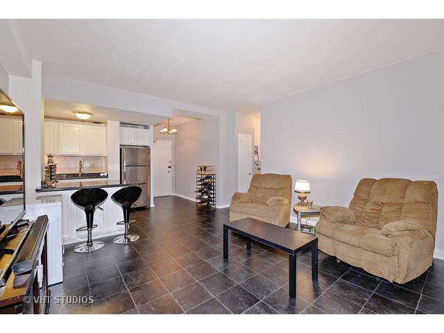 2909 North Sheridan Road, Unit 112 Chicago, IL 60657 - Photo 5 of 12 a living room with furniture and view of kitchen