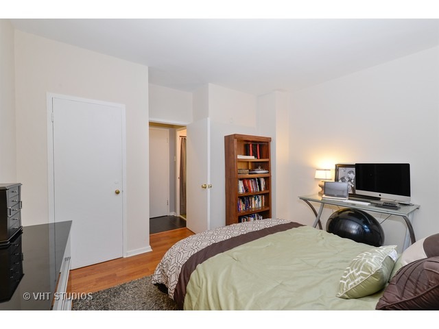 2909 North Sheridan Road, Unit 112 Chicago, IL 60657 - Photo 9 of 12 a bedroom with a bed and a television