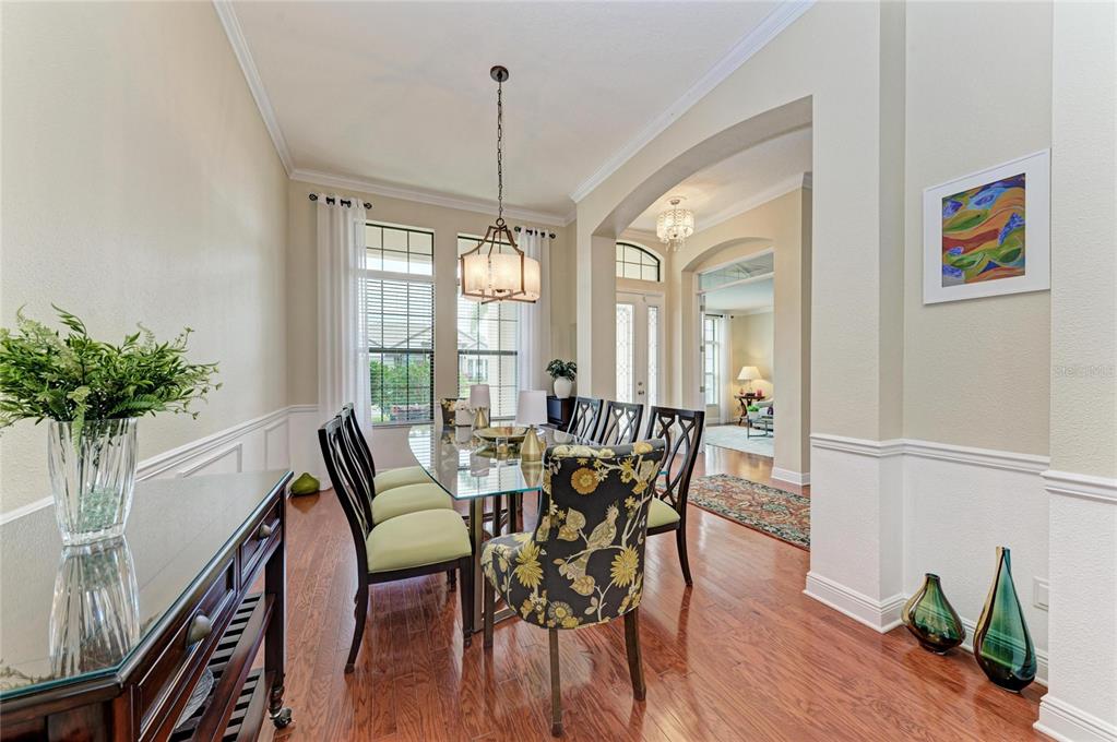 302 Cockle Shell Loop Apollo Beach, FL 33572 - Photo 14 of 75 a view of a dining room with furniture window and wooden floor