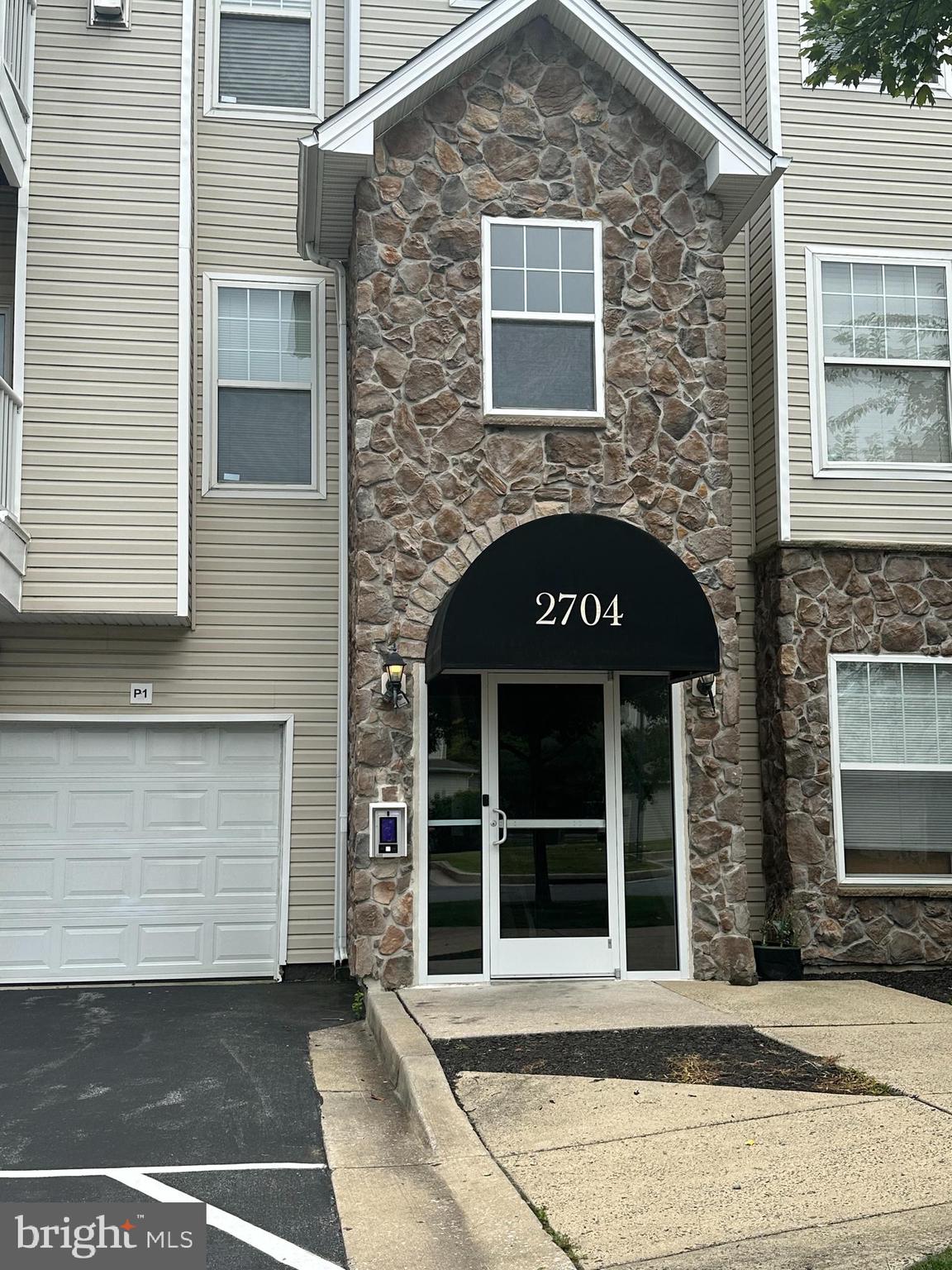 2704 Gresham Way, Unit 303 Windsor Mill, MD 21244 - Photo 2 of 2 a view of a brick house with a large windows