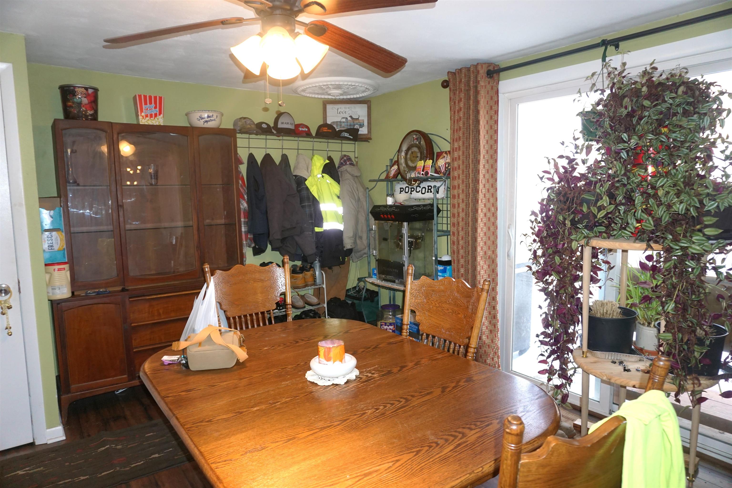 7402 Randy Road Machesney Park, IL 61115 - Photo 11 of 23 a living room with patio furniture and a chandelier