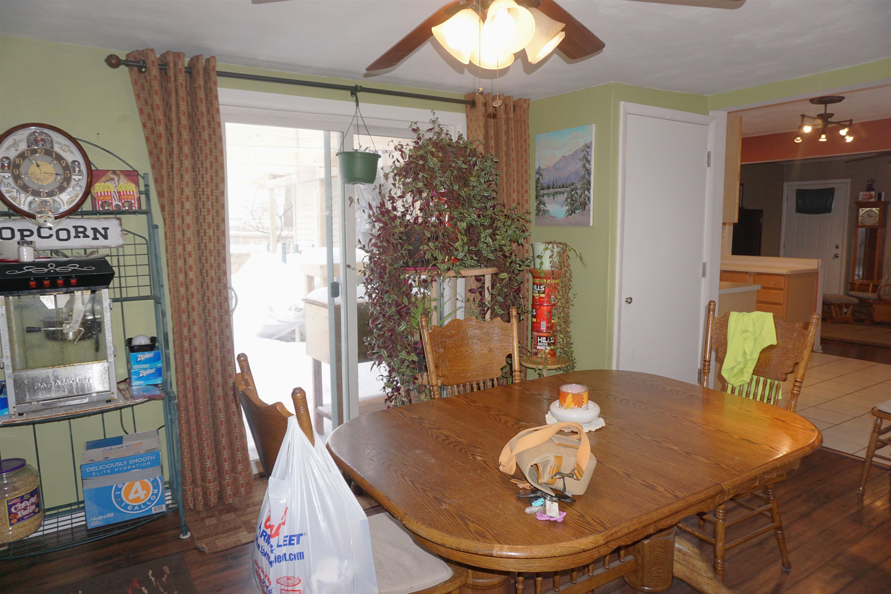 7402 Randy Road Machesney Park, IL 61115 - Photo 12 of 23 a view of a dining room with furniture a chandelier and wooden floor