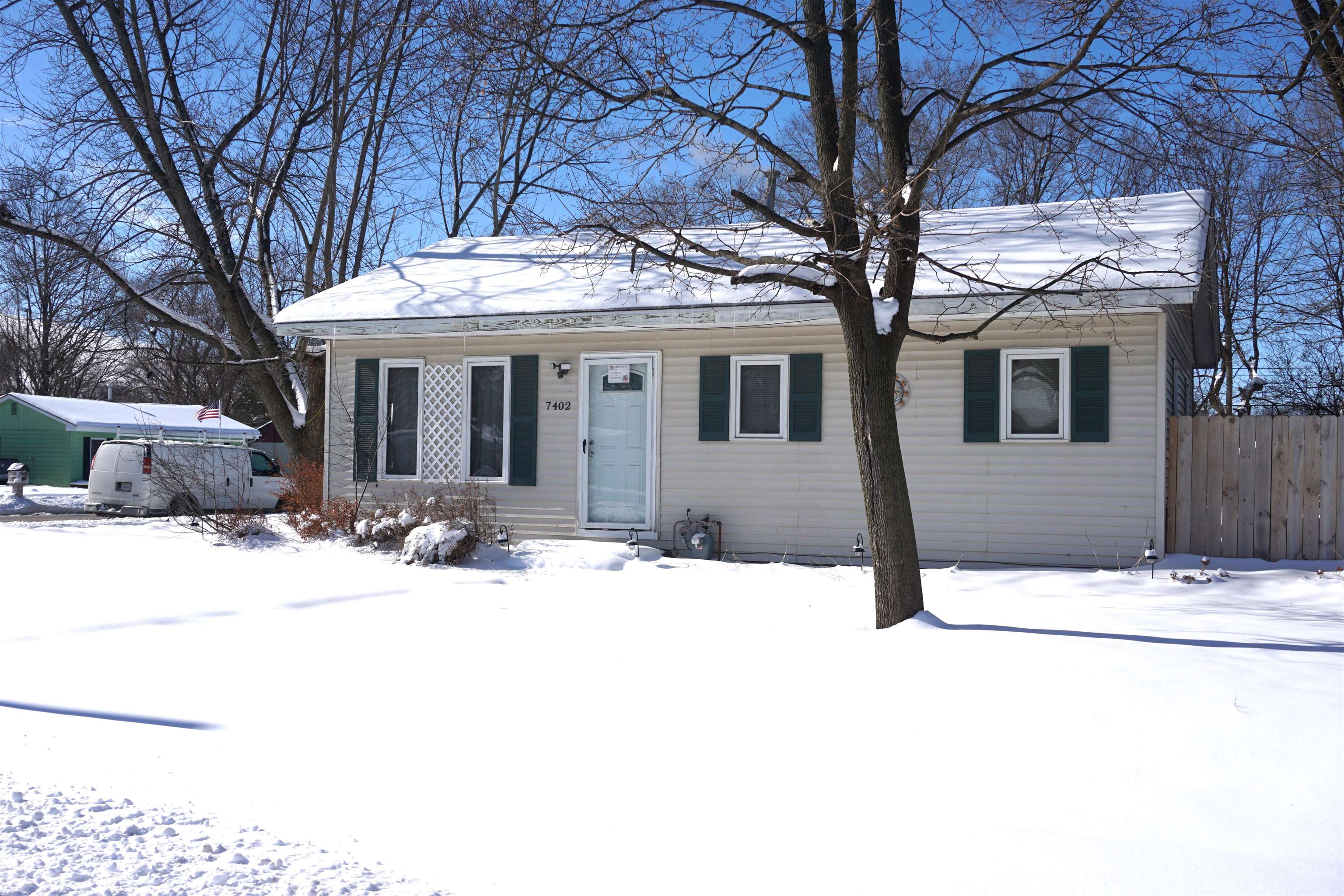 7402 Randy Road Machesney Park, IL 61115 - Photo 2 of 23 a view of a white house with a large tree