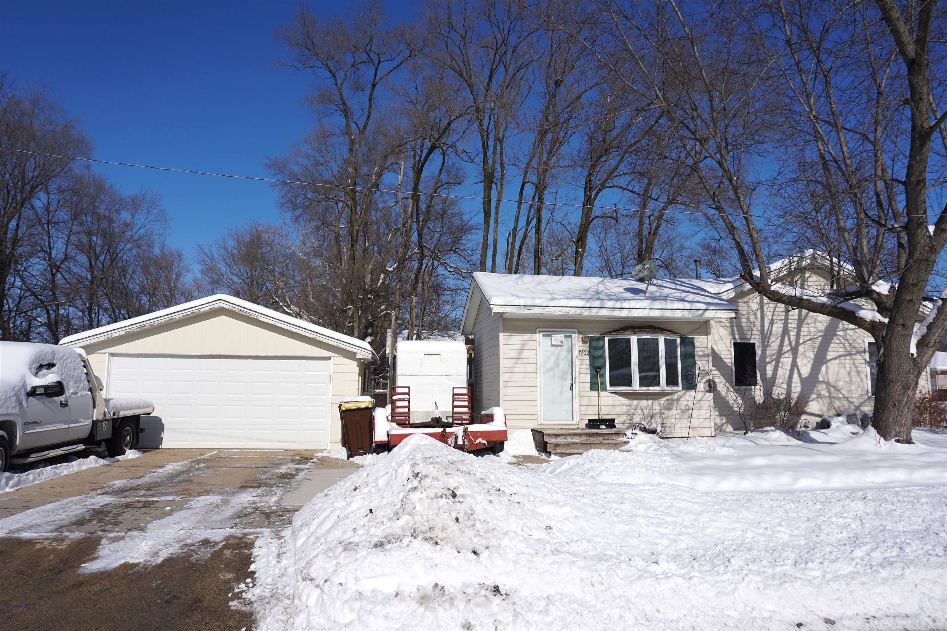 7402 Randy Road Machesney Park, IL 61115 - Photo 4 of 23 a view of a house with a yard covered in snow