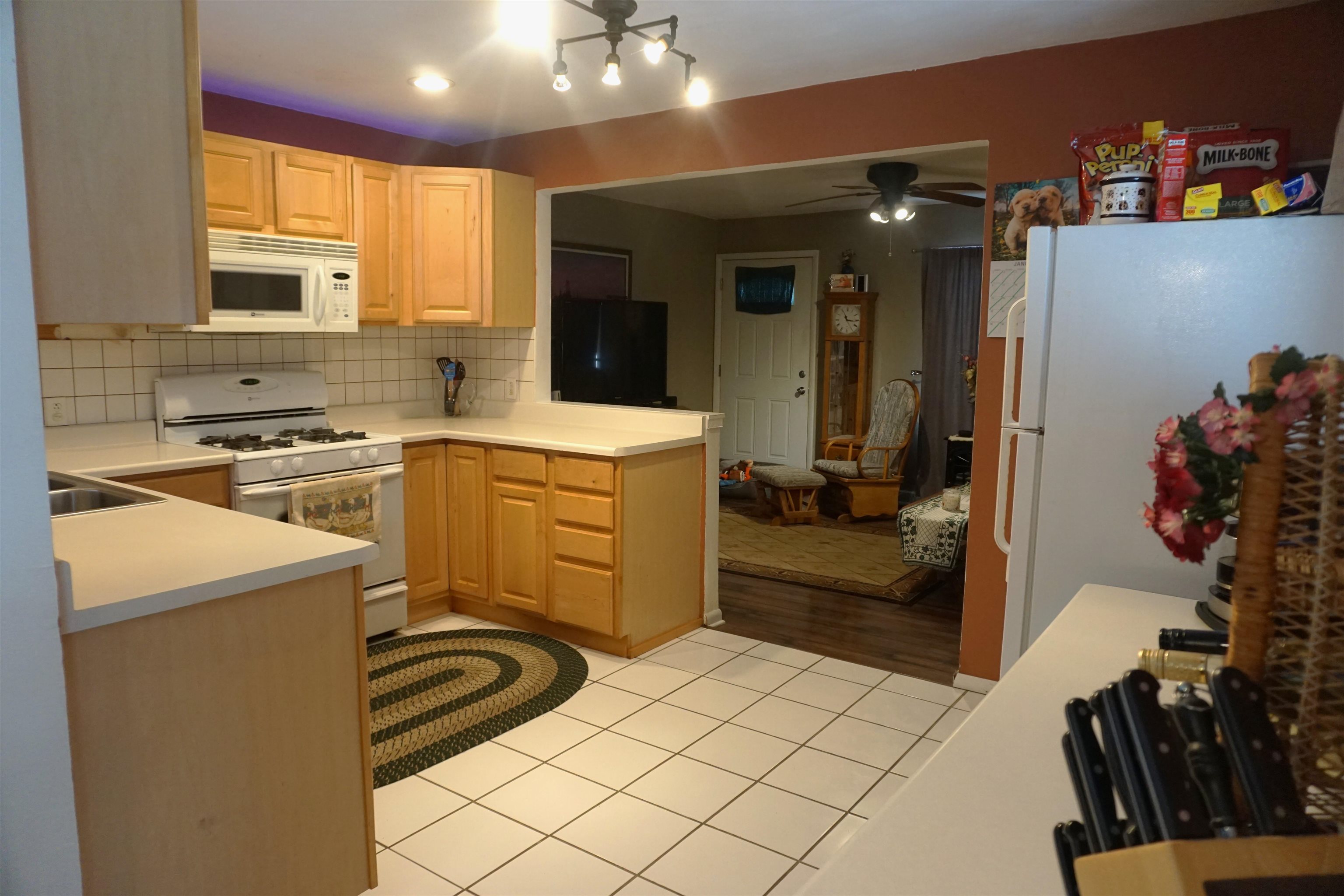 7402 Randy Road Machesney Park, IL 61115 - Photo 8 of 23 a kitchen with a refrigerator and a stove top oven