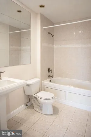 a bathroom with a toilet and a bathtub