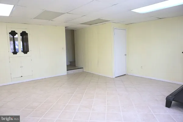 a view of a workspace with furniture and a bathroom