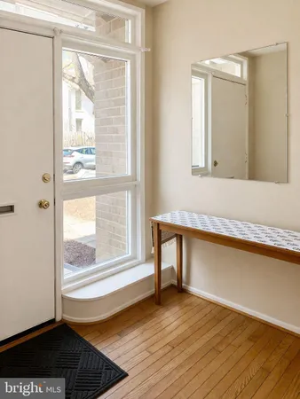 a view of a room with wooden floor and a window