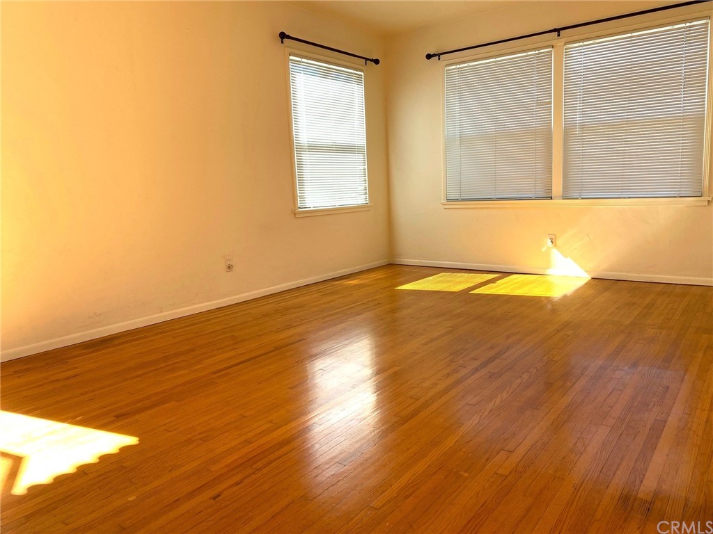 236 La Verne Avenue Long Beach, CA 90803 - Photo 2 of 8 a view of an empty room with wooden floor and a window