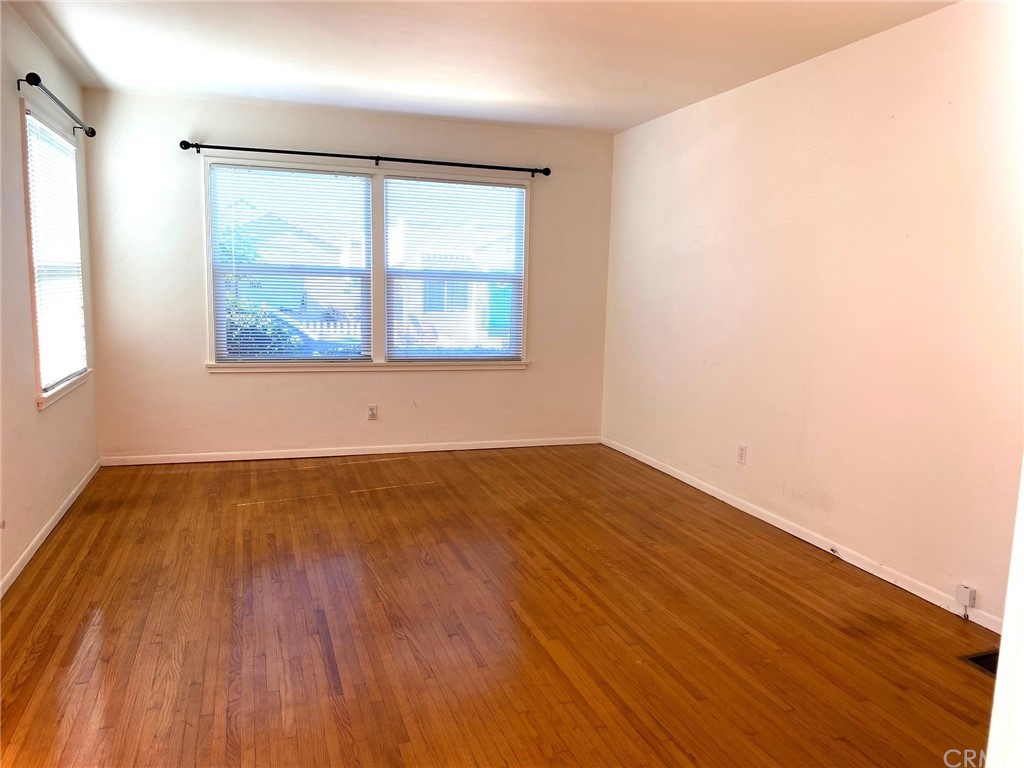 236 La Verne Avenue Long Beach, CA 90803 - Photo 3 of 8 an empty room with wooden floor and windows