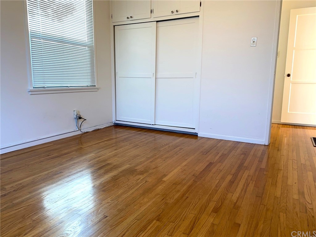 236 La Verne Avenue Long Beach, CA 90803 - Photo 7 of 8 an empty room with wooden floor and windows