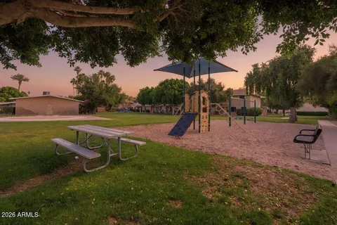 an outdoor space with lots of swings and slides