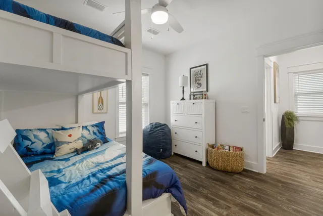 a bedroom with furniture and a wooden floor