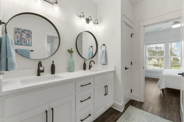 a bathroom with a double vanity sink and a mirror