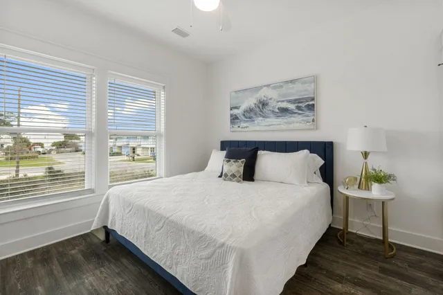 a bedroom with a bed and a painting on the wall