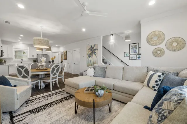 a living room with furniture kitchen view and a table