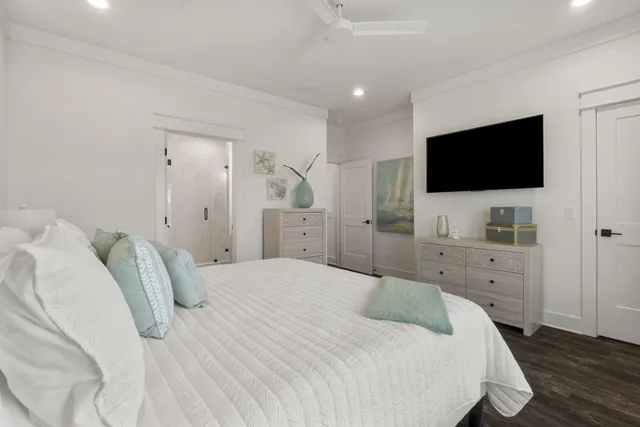 a bedroom with a bed and a flat screen tv