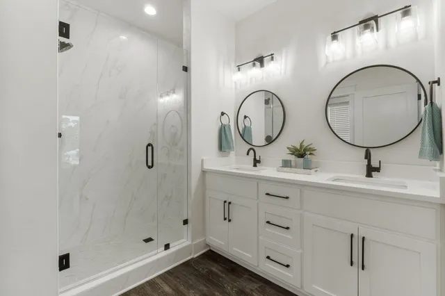 a bathroom with a double vanity sink and a mirror