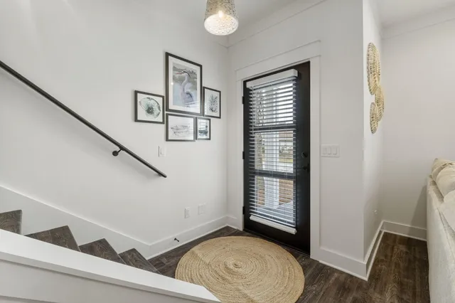 a view of entryway with stairs and wooden floor