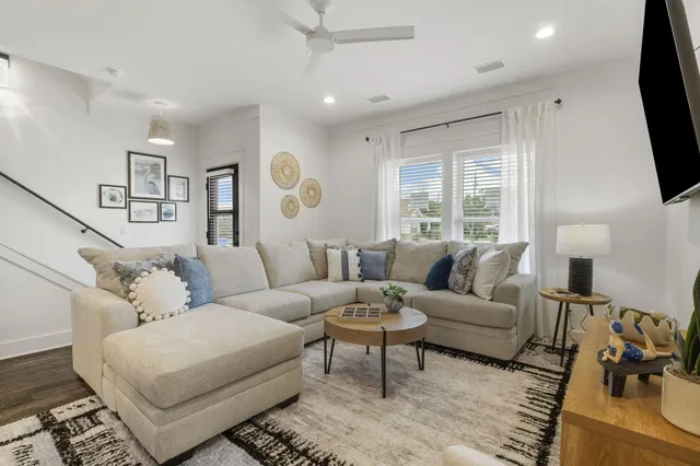 a living room with furniture flat screen tv and a window