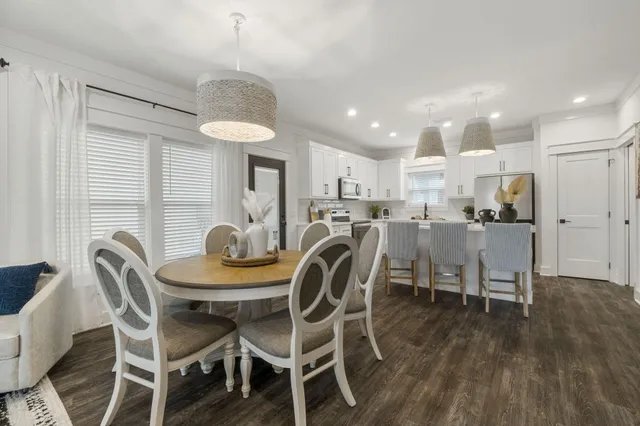 a dining room with furniture and a chandelier