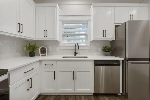 a kitchen with cabinets and stainless steel appliances