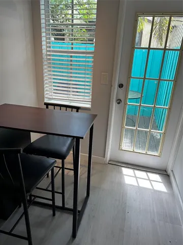 a view of a room with a window and wooden floor