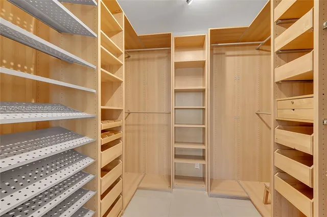 a view of walk in closet with empty racks
