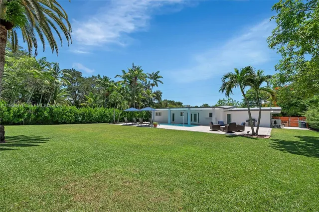 a view of a chairs and table in the yard