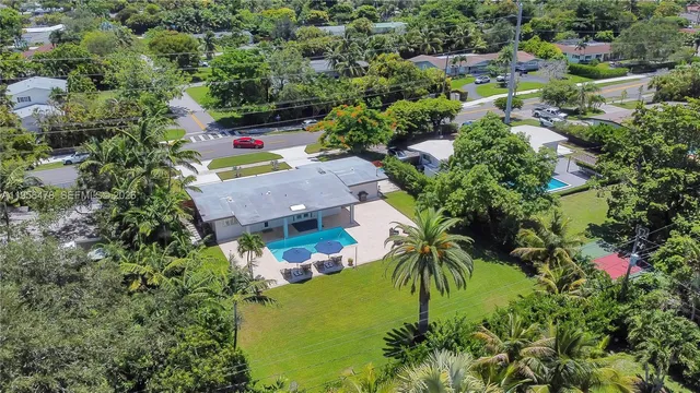 an aerial view of residential house with outdoor space and swimming pool