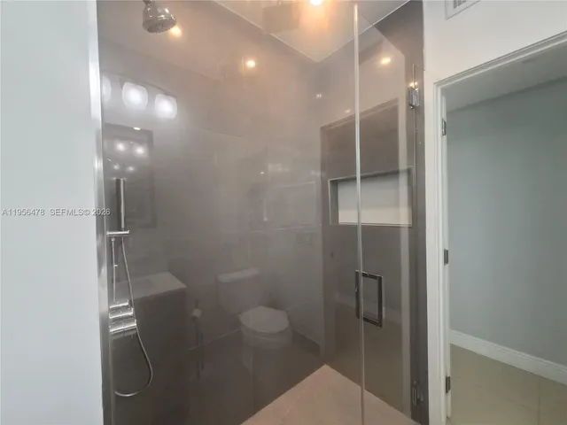 a bathroom with a shower and toilet