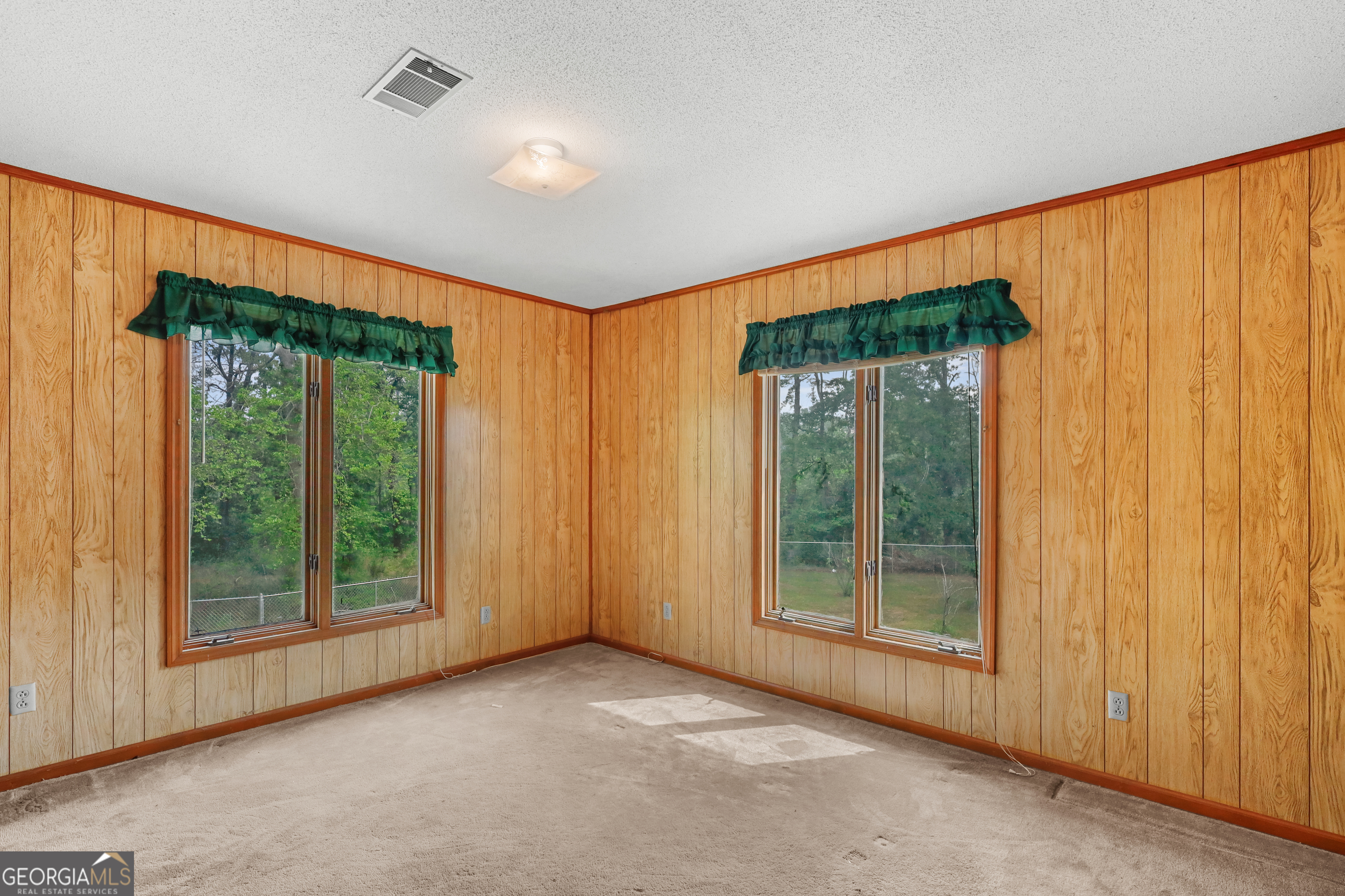 565 Bragg Road Brooklet, GA 30415 - Photo 24 of 44 an empty room with a window and front door