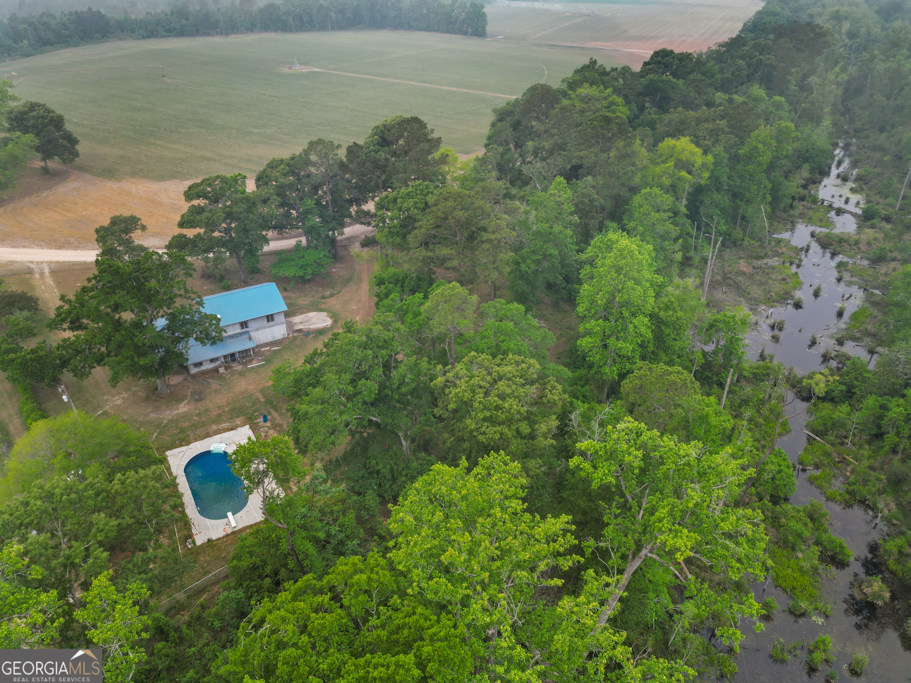 565 Bragg Road Brooklet, GA 30415 - Photo 35 of 44 an aerial view of a house with a yard and lake view