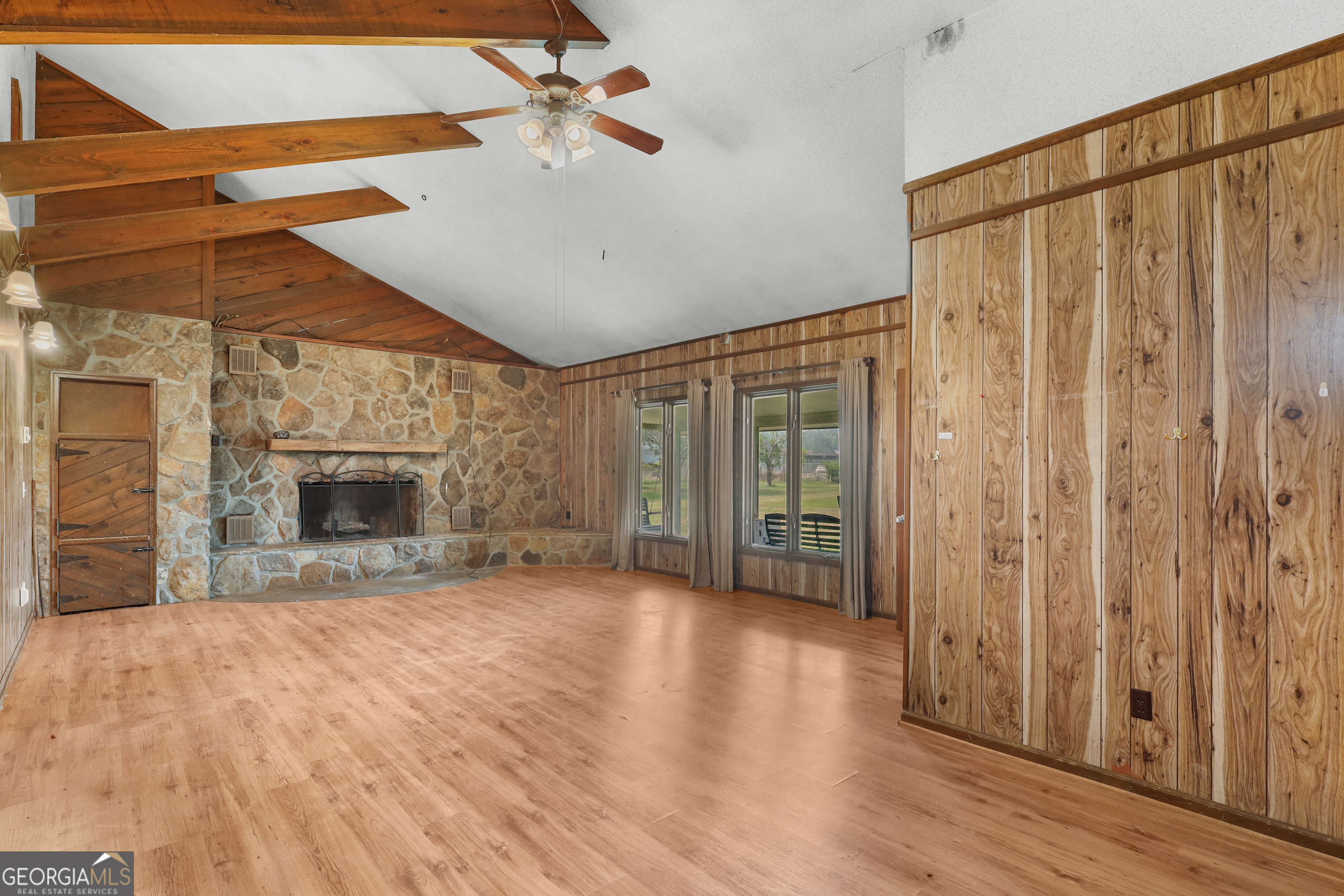 565 Bragg Road Brooklet, GA 30415 - Photo 6 of 44 a view of an empty room with wooden floor fireplace and a window