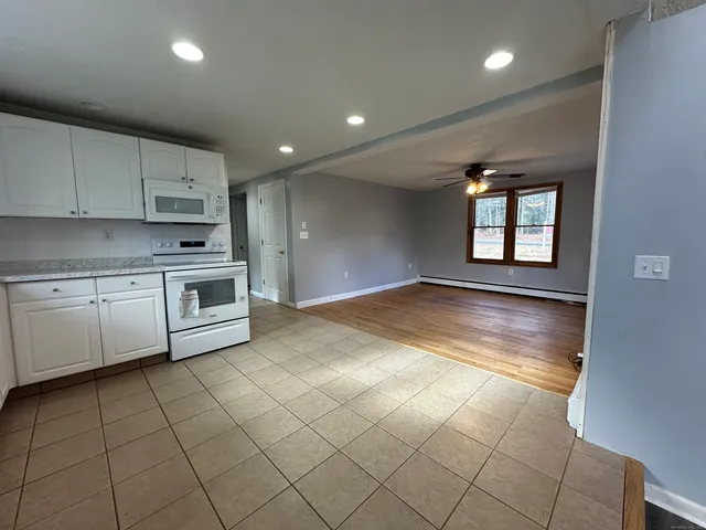 a kitchen with cabinets and window