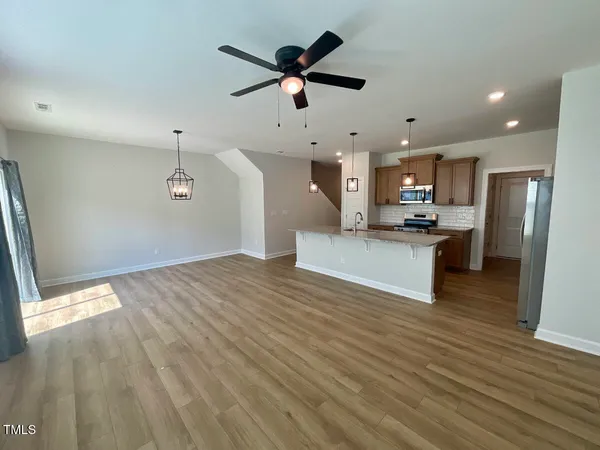 a kitchen with granite countertop cabinets and wooden floor