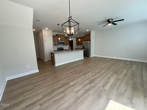 a view of empty room with wooden floor and ceiling window