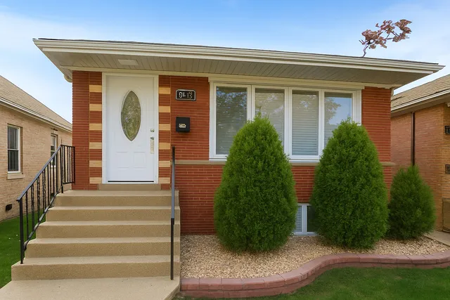 a view of a house with potted plants